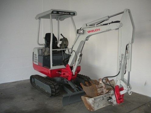 Mini pelle sur chenille caoutchouc